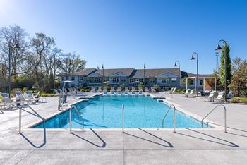 Resort-style pool with tanning ledges and cabanas